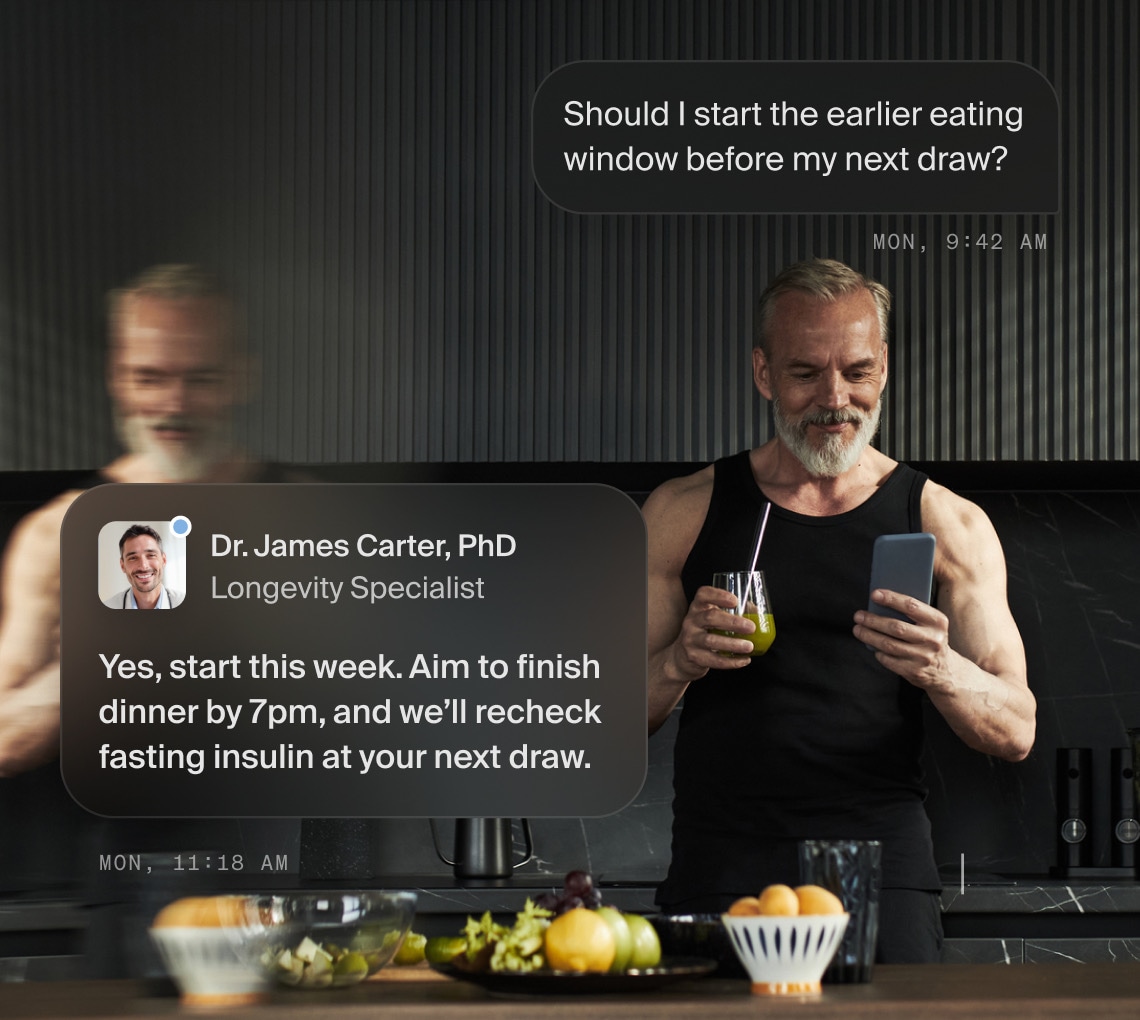 A man in his kitchen reading a follow-up recommendation about starting an earlier eating window
