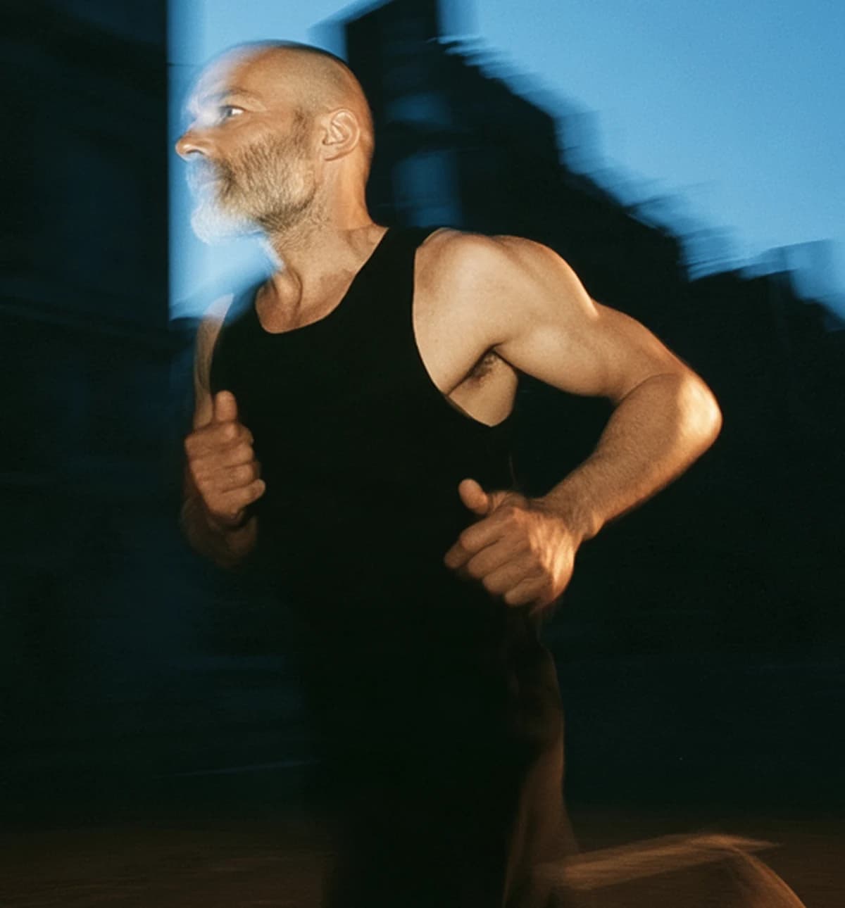 A man in his fifties out running at dusk